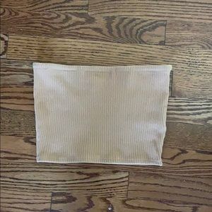 A beige tube top that is very flattering on !!